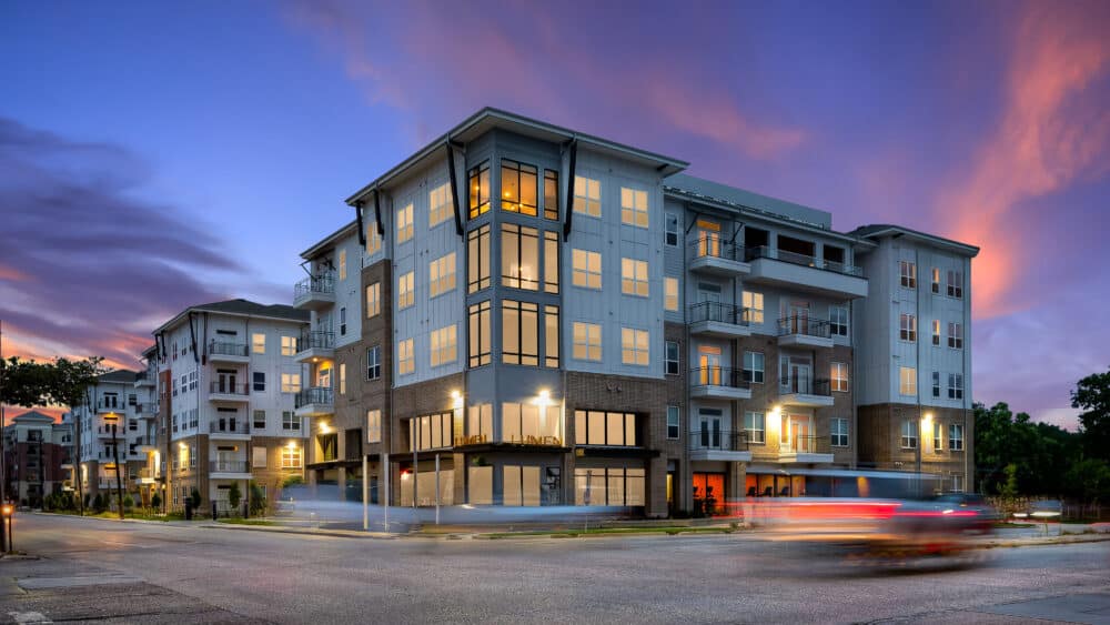 Modern Houston multifamily exterior photographed at twilight