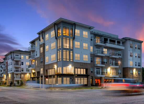 Modern Houston multifamily exterior photographed at twilight