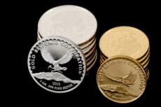 gold and silver coins product photography on black background Houston